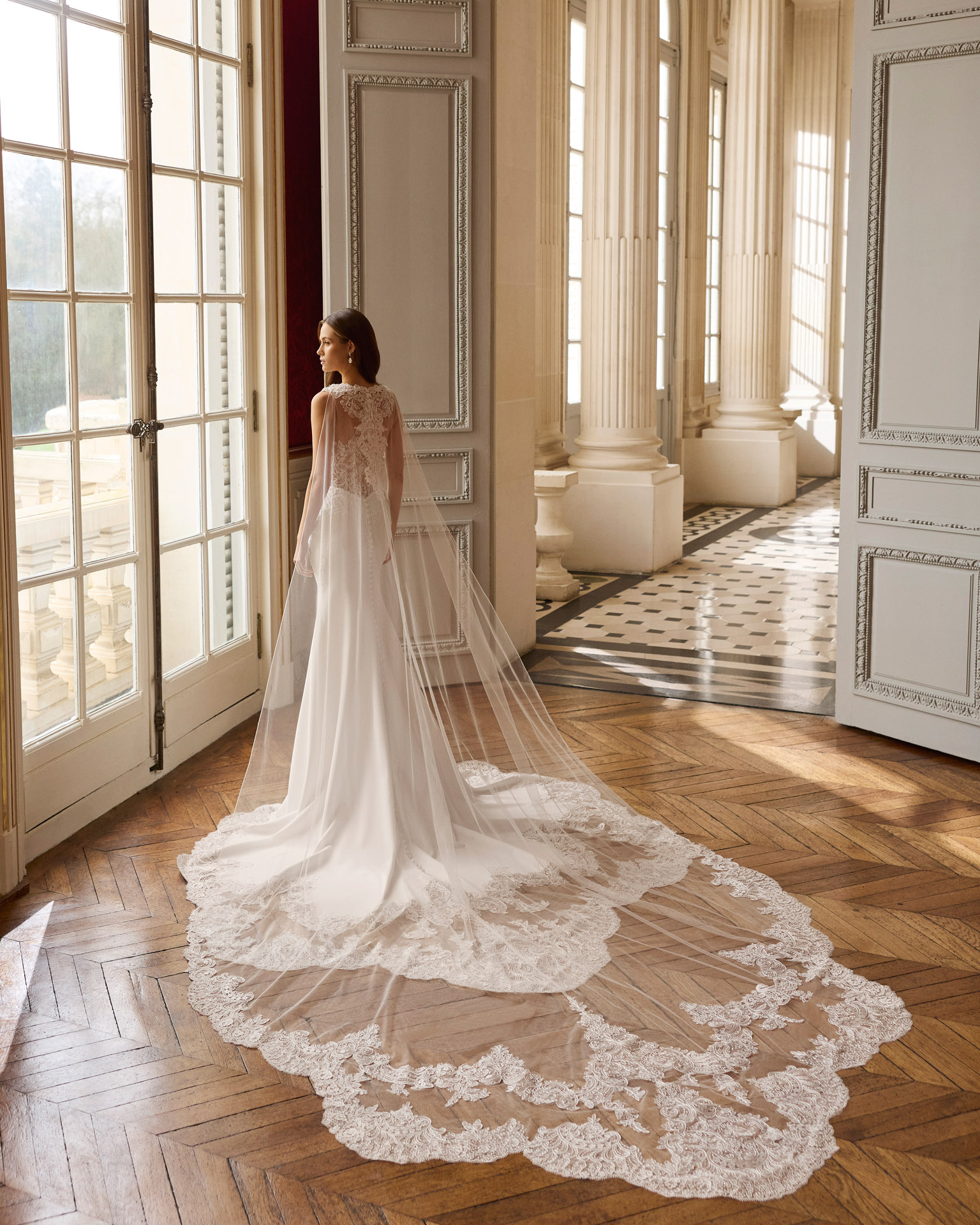 Vestido de novia Balma de Aire Barcelona 2027 de corte sirena con escote cuadrado, espalda transparente de encaje y cola con aplicaciones.