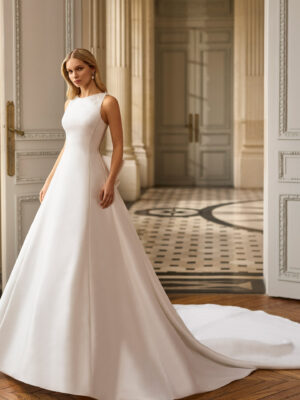 Vestido de novia Blayra de Aire Barcelona 2027 confeccionado en mikado con escote barco, espalda transparente bordada y gran lazo en la cintura.