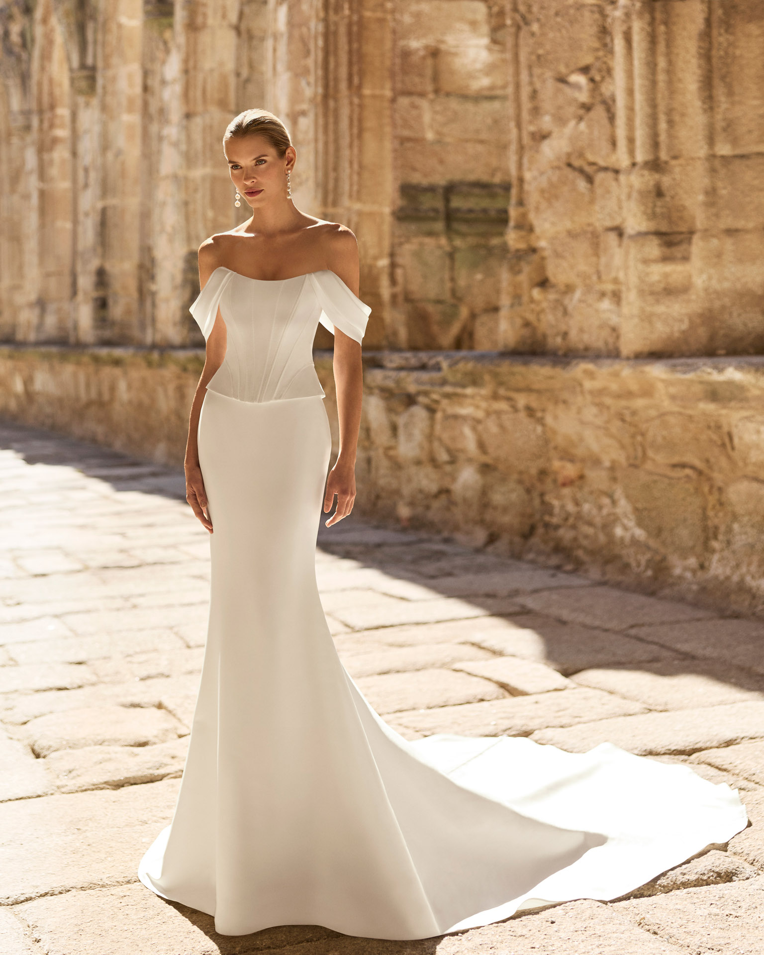 pravia-vestido-novia-sirena-escote-palabra de honor-mikado-adriana-alier-2027.webp Vestido de novia Pravia de Adriana Alier 2027 de corte sirena en mikado con escote barco, hombros caídos, corsé estructurado y espalda descubierta.