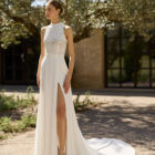 Vestido de novia Mary de Alma Novia con cuerpo de encaje, cuello alto y falda con abertura