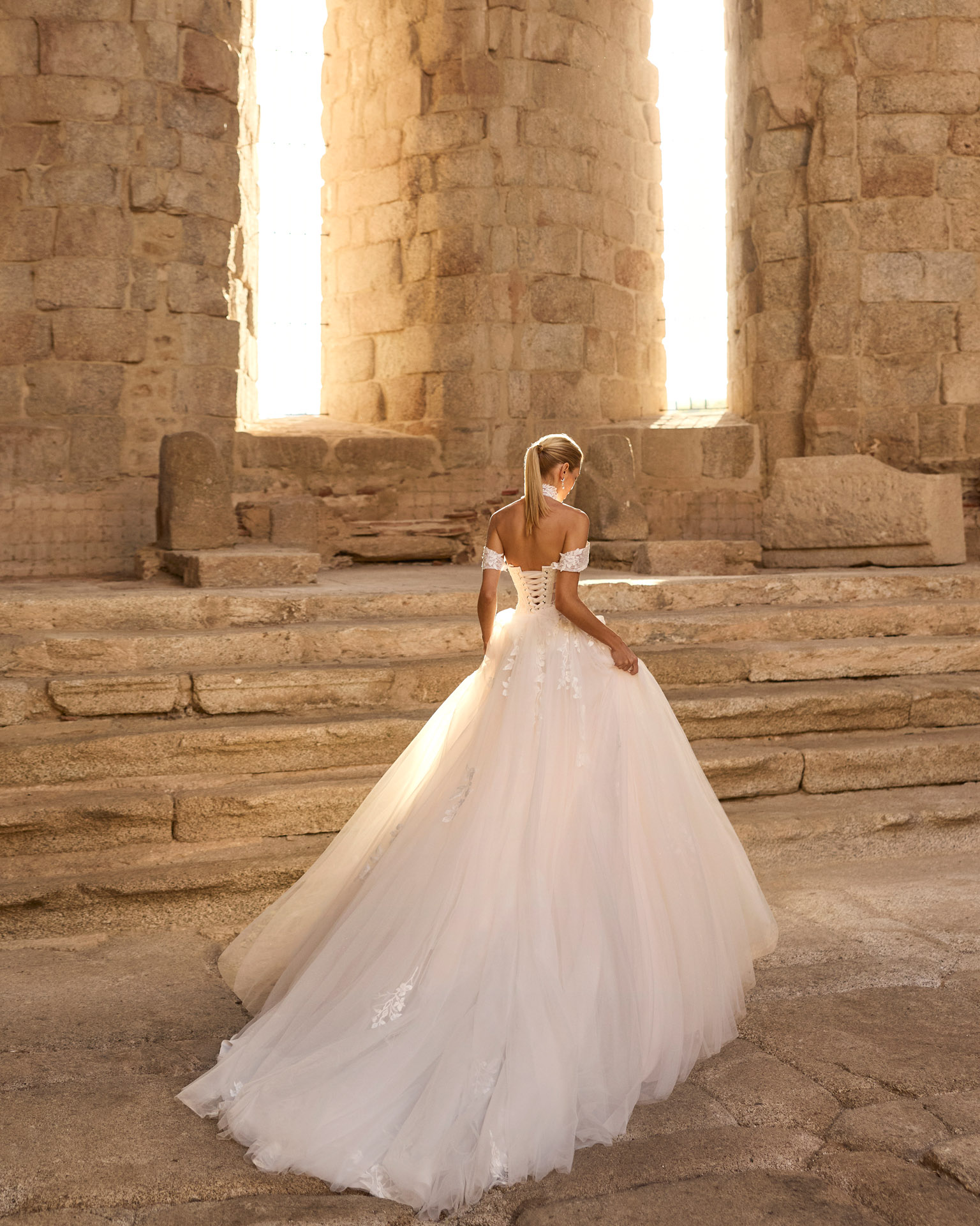 Vestido de novia Persa de Adriana Alier con corsé de encaje, hombros descubiertos y falda de tul